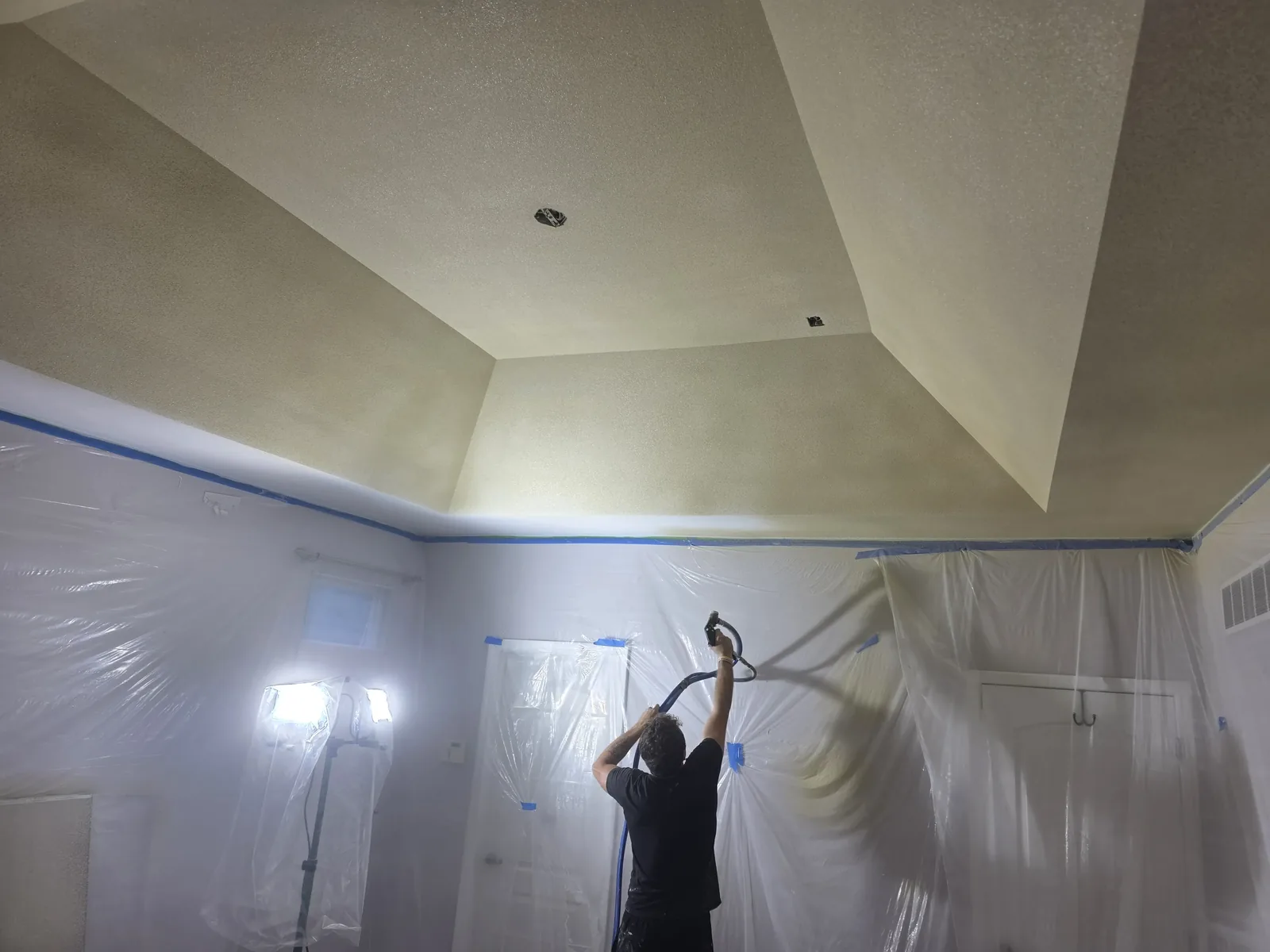 Applying spray texture to a tray ceiling during a Carleton, MI drywall job