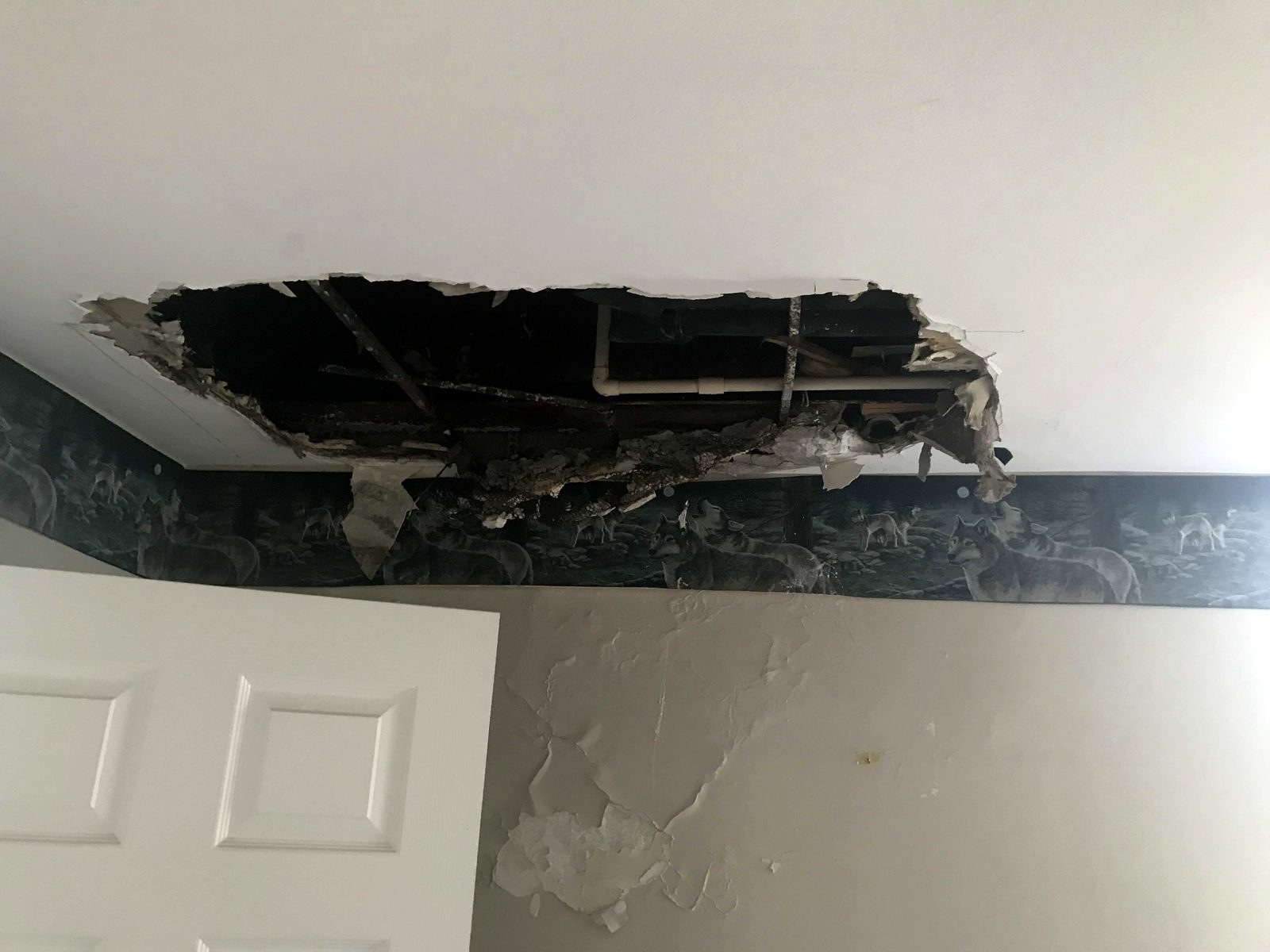 Ceiling stained and sagging from a slow water leak before repair