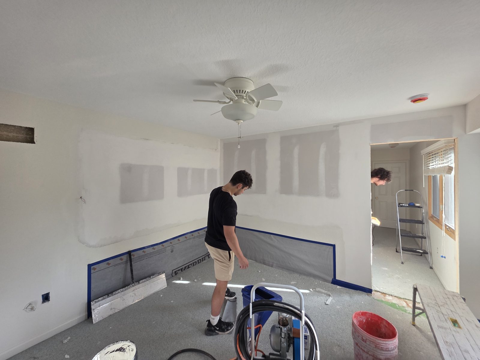 TDM Drywall crew finishing drywall in a room in Monroe, MI